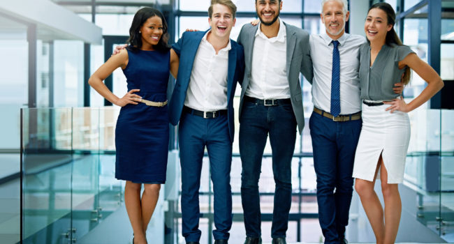 Portrait of a group of colleagues standing together in an office